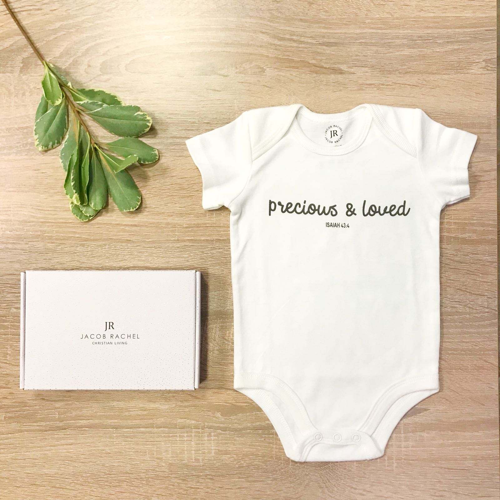 ROCKONLINE | New Creation Church | NCC | Joseph Prince | ROCK Bookshop | ROCK Bookstore | Star Vista | Lifestyle | Mothers | Baby Shower | Gift Ideas | Scriptures | Baby Onesie Precious & Loved by Jacob Rachel | Free delivery for Singapore Orders above $50.